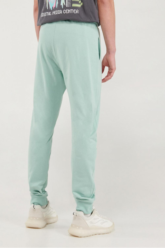 Pantalón jogger crema con pretina y puños en rib